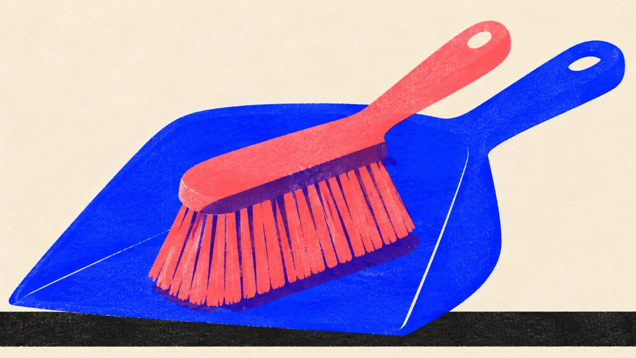 Illustration of a dustpan with a hand brush resting in its scoop.
